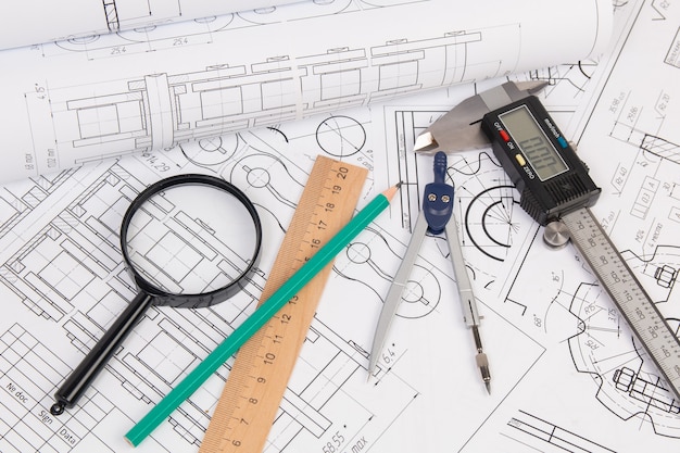 Engineer industrial chain drawings, engineering compass, magnifying glass, caliper and pencils