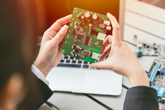 Engineer inspect final production of Printed circuit computer logic board of router modem prepare for mass production process.