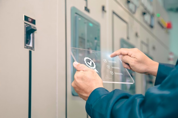 Engineer inspecting high voltage control equipment, maintenance concept.