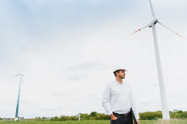 Engineer inspecting Project Manager at the Wind Farm. Man working in the enviromental