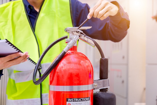 Engineer inspection Fire extinguisher in control room.