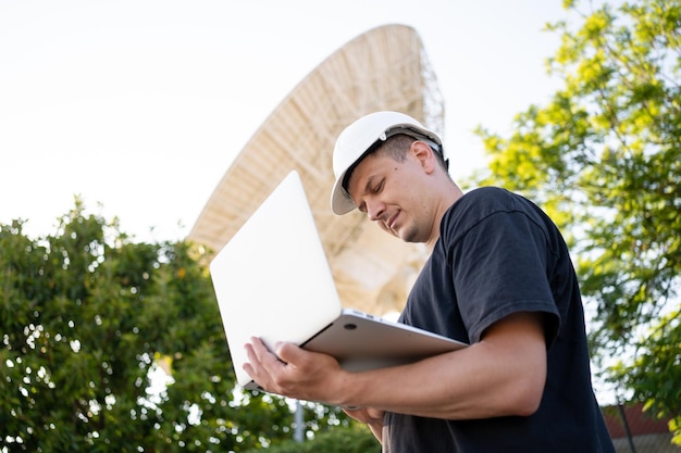 Engineer looking earth based astronomical radio telescope