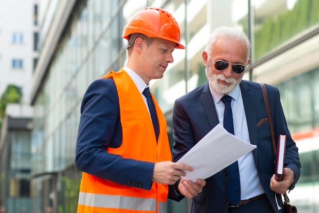 Engineer man talking with senior business man