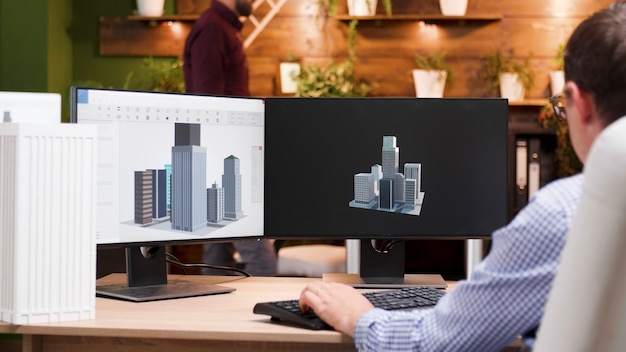 Engineer man working at architectural building prototype on computer using digital company software. Workaholic architect developing industrial construction structure for creativity project