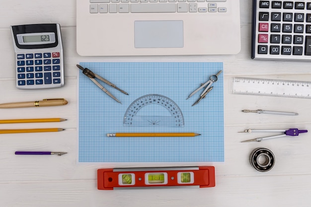 Engineer's workplace with millimeter paper and draw equipment