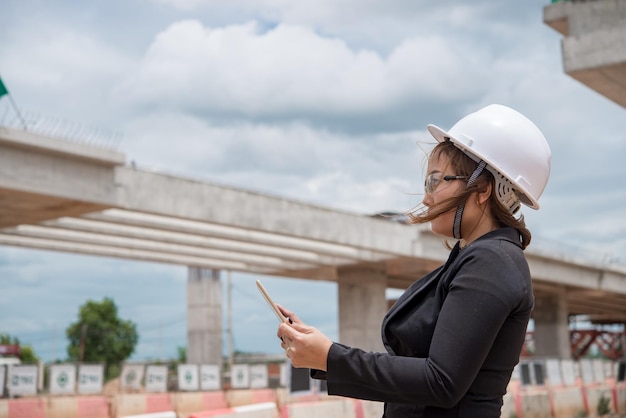 Engineer woman working at site of bridge under construction