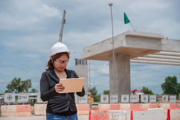 Engineer woman working at site of bridge under construction