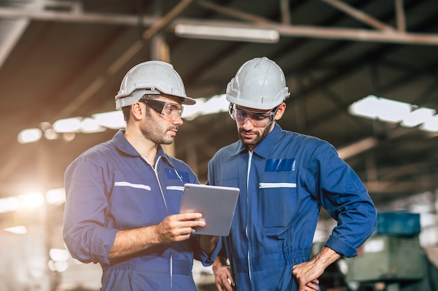 Engineer worker friend people team working discussion help support together at work in heavy industry factory.