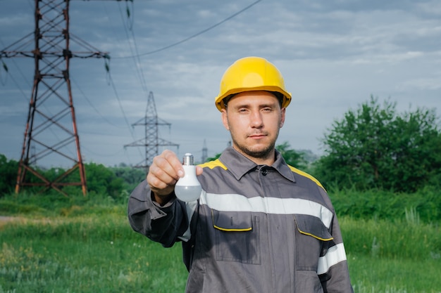 Engineer-worker in a hard hat and protective clothing