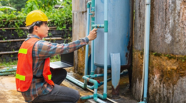 Engineer working check water management system and boiler water pipe outside the factory