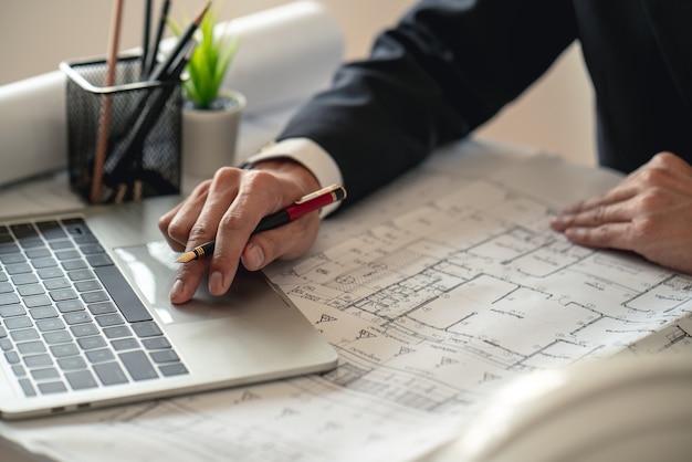 Engineer working on construction site with drawing document