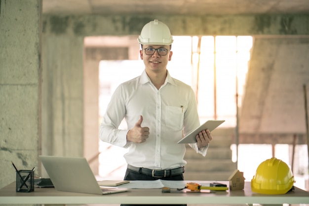 Engineer working with computer laptop about construction plan on site