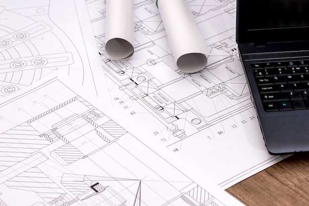 Engineering drawings of parts with a laptop