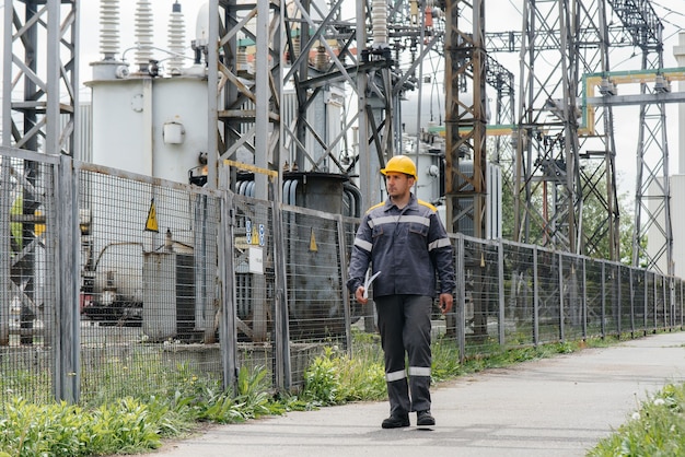 Photo an engineering employee makes a tour and inspection of a modern electrical substation. energy. industry.