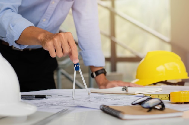 Engineers are planning a structure sketch with circular tools Complete with architect equipment