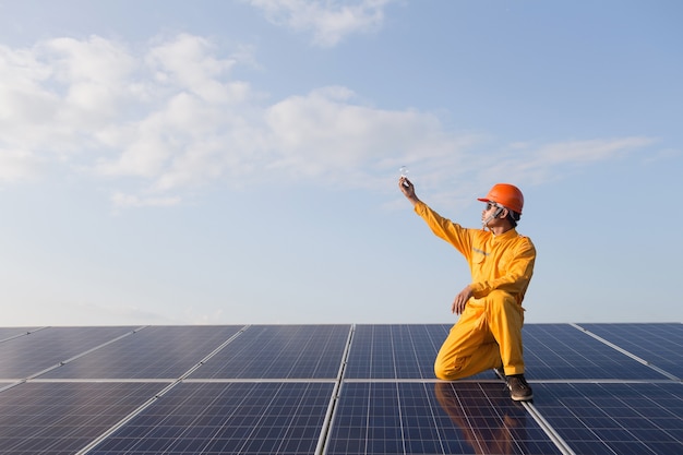 Engineers checking solar panels,Holding the bulb on the Solar Panel. The concepts of Clean