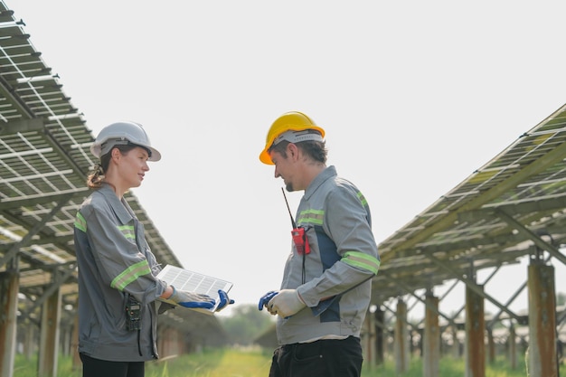 Engineers Meeting to check solar panel at roof top solar farm with an energy storage system operated by Super Energy Corporation Specialists Gathered for Outdoor testing Photovoltaic cells module