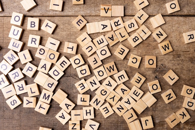 Photo english alphabet wooden letters on a wooden background a letter mess