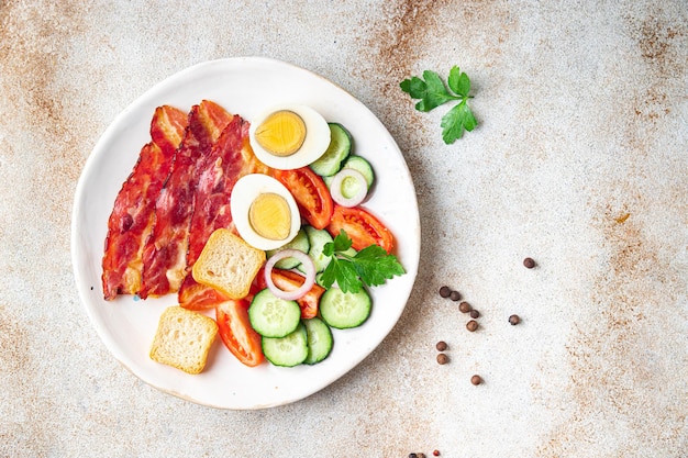 English breakfast eggs bacon tomato cucumber toast bread healthy meal diet snack on the table