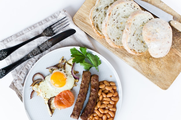 English Breakfast on a grey plate on a white background.