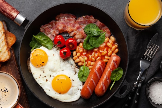 English breakfast with fried eggs beans bacon and sausages