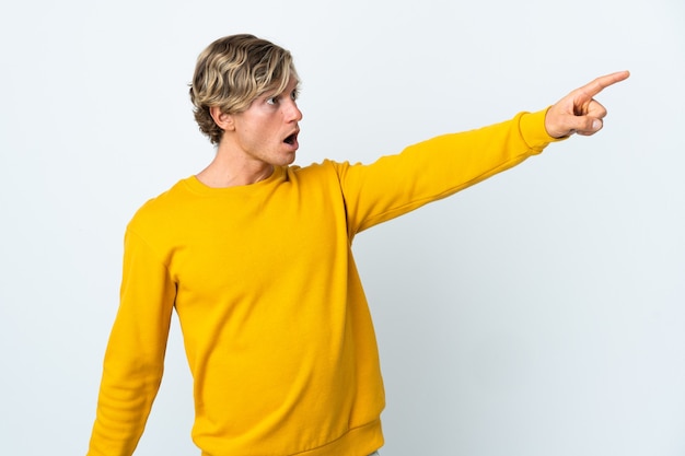 English man over isolated white background pointing away