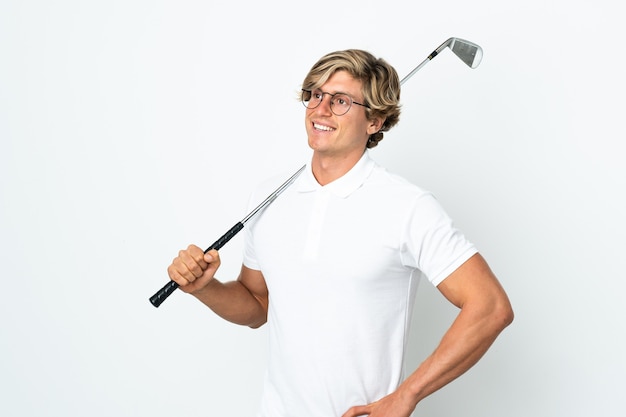 English man playing golf posing with arms at hip and smiling