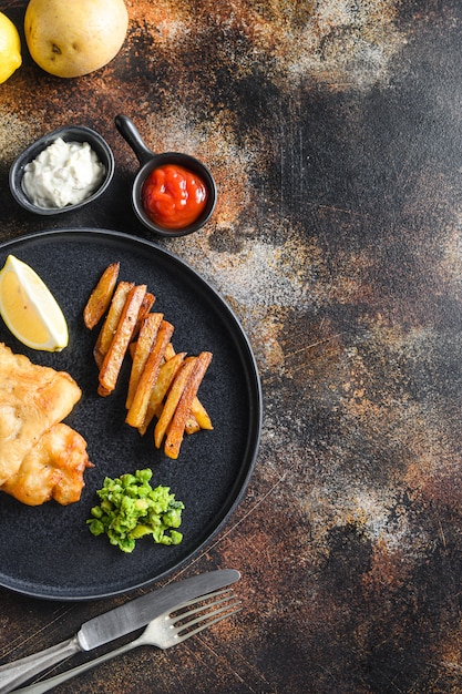 English Traditional Fish and chips with mashed minty peas and tartar sauce