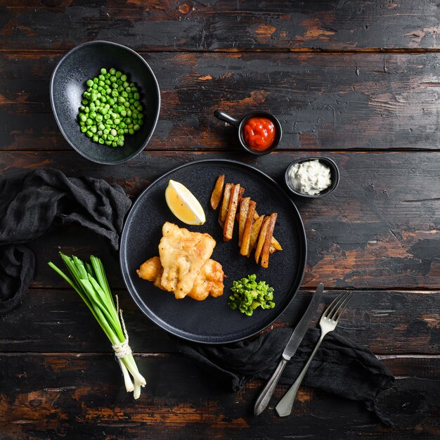 English Traditional Fish and chips with mashed minty peas and tartar sauce