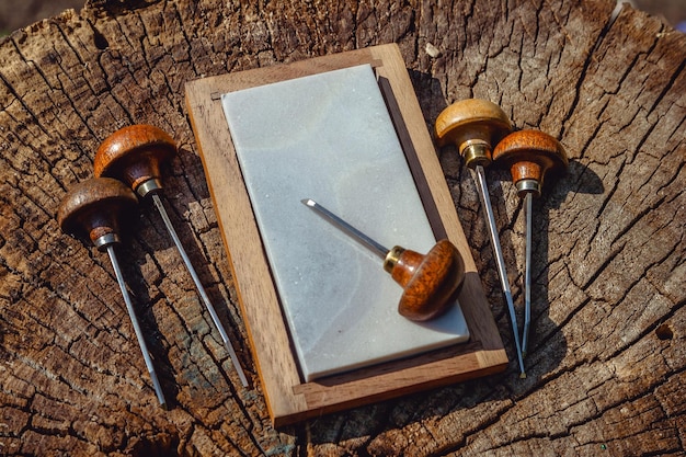 Engraving shtikhel and grindstone on a wooden background