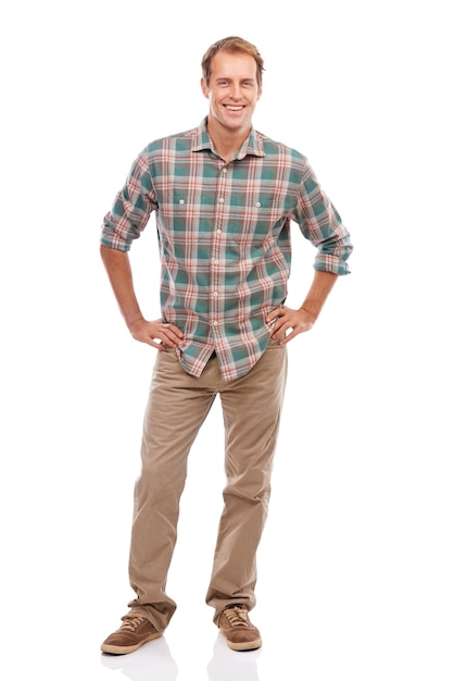 Enjoying the casual life Portrait of a handsome young man standing with his hands on his hips against a white background