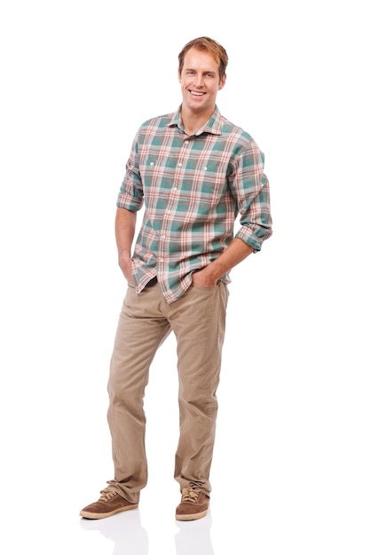 Enjoying the casual life Portrait of a handsome young man standing with his hands in his pockets against a white background