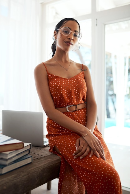 Enjoying the freedom of freelancing cropped portrait of an attractive young businesswoman sitting on