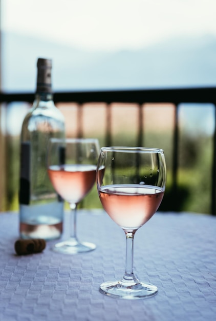 Enjoying a glass of rose wine on the veranda summer holiday in Italy