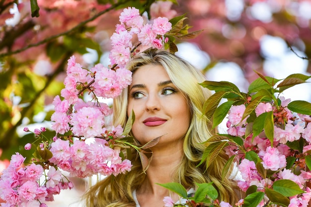 Enjoying spring day carefree and happy woman sexy girl enjoy sakura bloom spring blossoming tree pink cherry tree flowers floral aroma treatment vintage and retro fashion pure beauty female