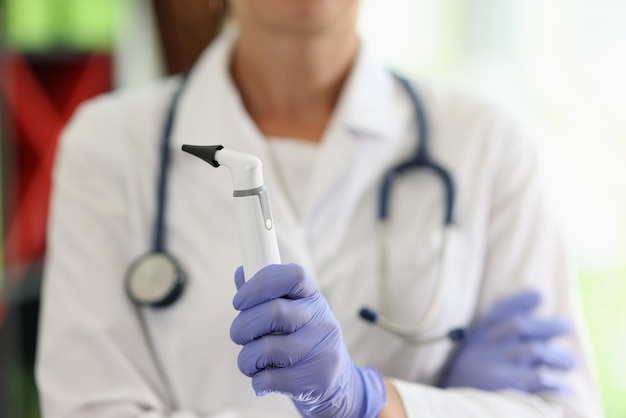 Ent woman doctor with diagnostic tools closeup otolaryngologist holds medical instrument in