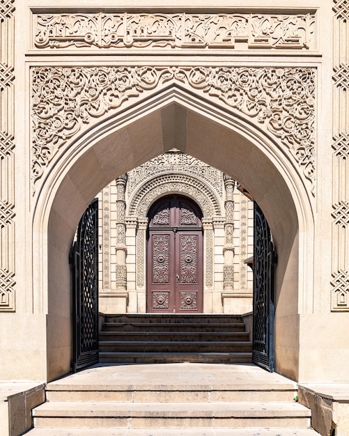 Entrance to ancient mosque decorated with beautiful carved stone in old city Baku Azerbaijan