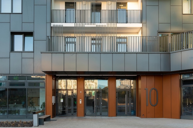 Entrance of an apartment building with a gray facade