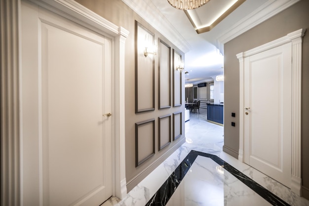 Entrance corridor in a new apartment with a fresh renovation in a minimalist style Beigebrown tones marble floors