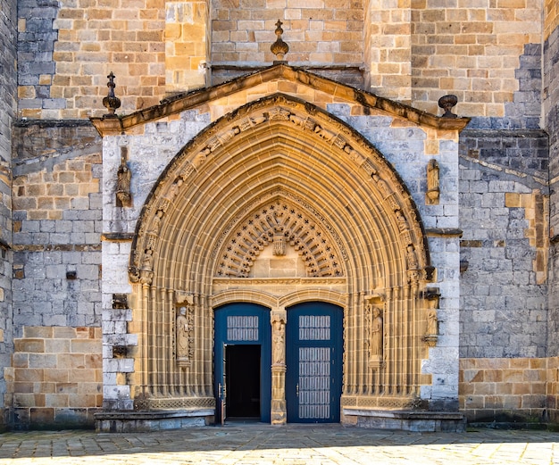 Entrance door and main facade of old stone church of Andra Maria in Guernica, Basque Country, Spain