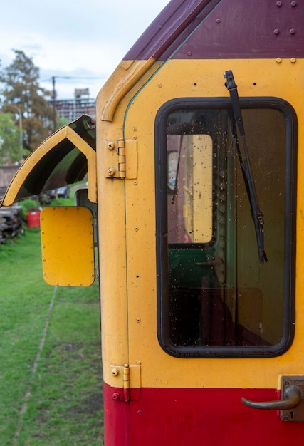 Entrance door to old train locomotive with window and windshield wipers