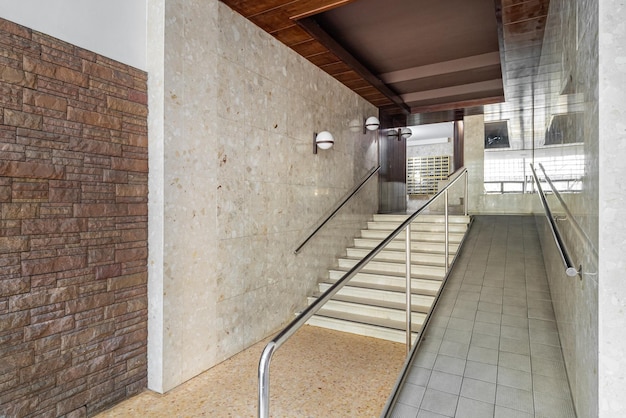 Entrance of a house with long corridor stairs to elevator area with ramp for disabled person