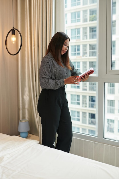 Entrepreneur Standing at Hotel Room Window