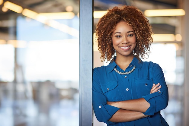 Entrepreneurs doing what they do best Portrait of a smiling young professional standing in a modern office