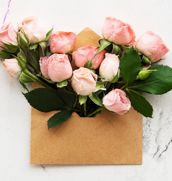 Envelope and pink roses