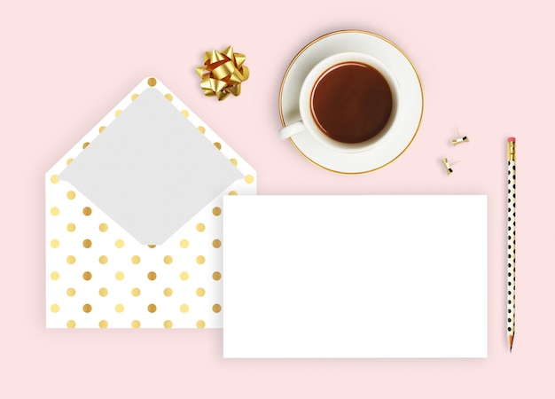 envelope polka gold, coffee cup and pencil. 