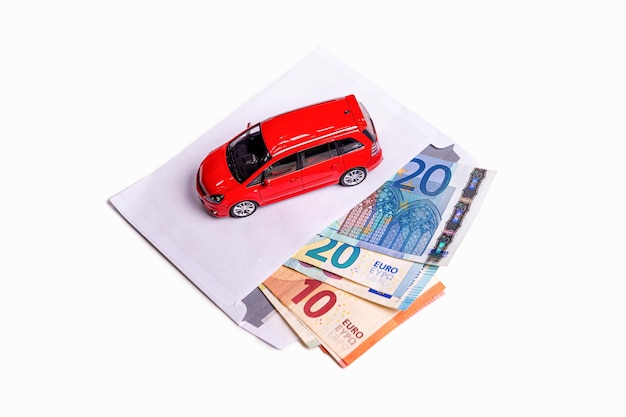 Envelope with euro banknotes and car isolated on white transportation cost planning concept