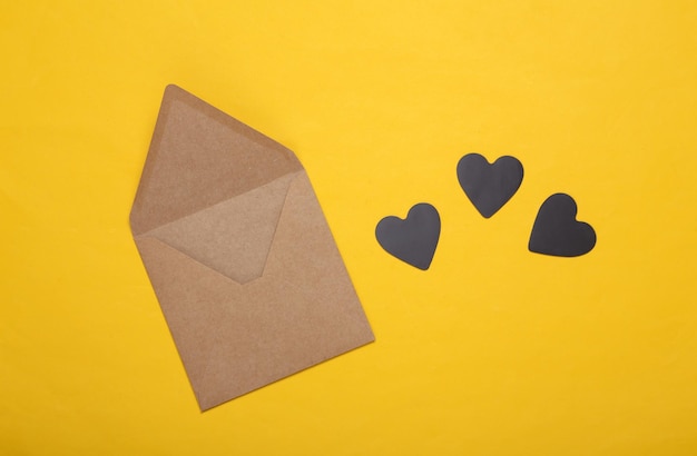 Envelope with hearts on a yellow background Love concept