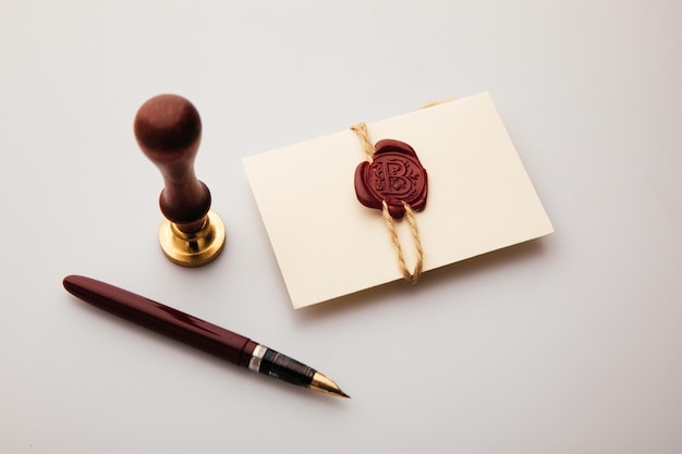 Envelope with wax stamp and pen on a table