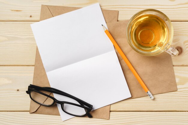 Envelopes with cup of tea on wooden table top